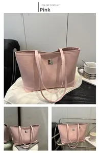 Detailed view of pink tote bag featuring cartoon smile and cloud embossing with metal logo