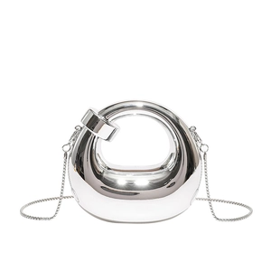 Silver mirror-finish mini round crossbody bag with sleek metallic luster and chain strap