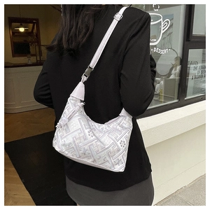 Detail of lavender crescent hobo bag with geometric embroidery and side knot accents