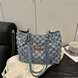 Blue denim checkered tote bag with frayed edges and brown leather tag for women
