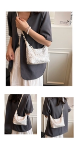 Close-up of elegant floral embroidery and tassel detail on this white crossbody bag