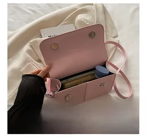 Internal capacity of pink woven crossbody bag showing space for wallet and cosmetics