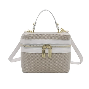 Minimalist beige canvas box bag with white leather trim and gold-tone hardware