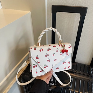Fashionable cherry print crossbody bag with woven top handle and white leather finish