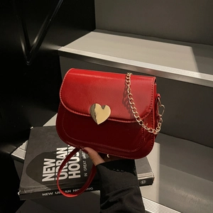 Minimalist red leather square saddle bag with gold heart buckle and chain strap