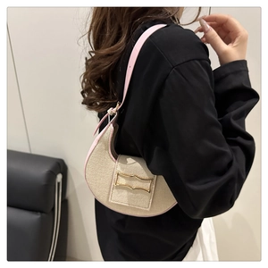 Detailed close-up of the moon-shaped bag featuring canvas texture and pink leather trim
