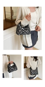 Detail of Chinese style embroidered black crossbody bag with decorative pearl clasp detail