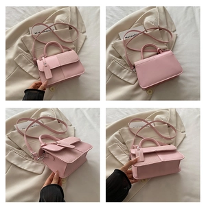 Detail view of pink crossbody bag with faux leather and fabric patchwork and strap