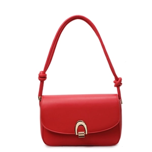 Chic red shoulder bag with gold U-shaped buckle and knotted strap on white background