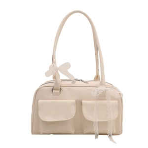 Fashionable off-white shoulder bag with dual pockets and lace bows on a white background