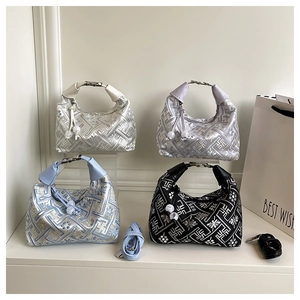 Detail of four hobo bags with jacquard fabric, metal buckles and bead drawstrings