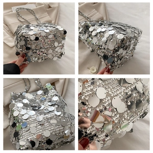 Detailed view of shimmering silver sequins and sleek metal chain on a bucket bag