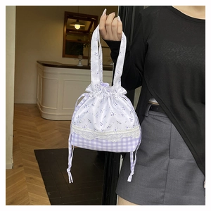 Close-up of floral bucket bag with purple checkered pattern and lace trim details