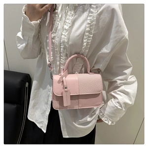 Pink contrast patchwork crossbody bag shown on white blouse for a stylish summer look