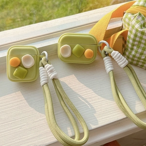 Grass green silicone AirPods case with cute 3D charms and thick woven lanyard strap