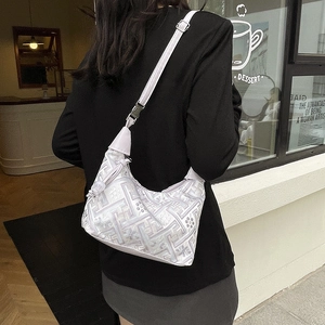 Elegant grey Chinese embroidery shoulder bag with adjustable strap on urban model