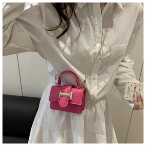 Detail of rose pink mini crossbody bag with gold chain strap and metal buckle