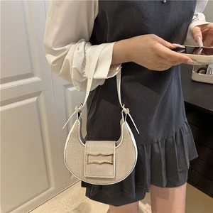 Minimalist canvas crescent shoulder bag with white leather trim and gold buckle