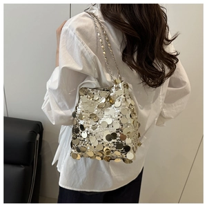 Detailed view of shimmering sequins and delicate metal chain on a bucket bag