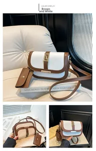 Detail view of contrast stitching saddle bag in coffee and white leather with gold buckle