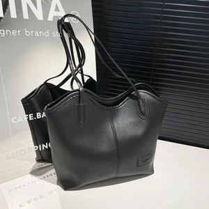 Minimalist black PU leather tote bag with wavy top edge and twin handles for women