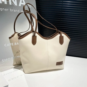 Retro cream and brown leather tote bag with a spacious interior and minimalist chic style