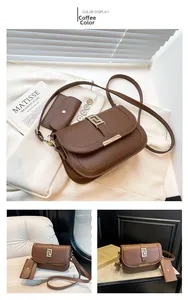 Detail view of coffee brown shoulder bag with Greek key buckle and mini pouch