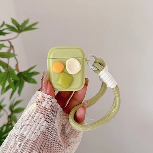 Light green silicone AirPods case with geometric patches and braided hand strap