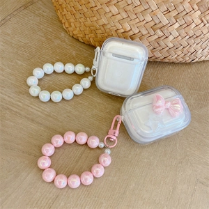 Close-up of clear AirPods cases with star bow charms and aurora beaded hand straps