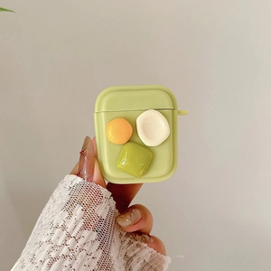 Detail of light green silicone AirPods case with 3D colorful geometric shapes