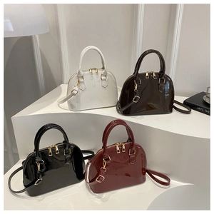 Detail shot of gloss patent shell bags in white, coffee, black, and wine red colors