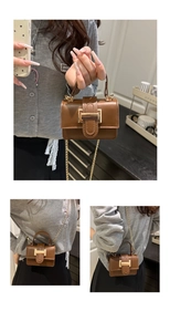 Close-up of brown PU leather mini square bag with gold metal buckle and chain strap