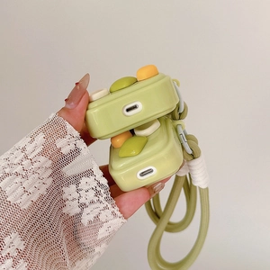 Close-up of retro game console style silicone case for AirPods with a green lanyard