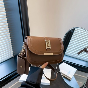 Retro brown flap crossbody bag with golden geometric buckle and mini coin purse attachment