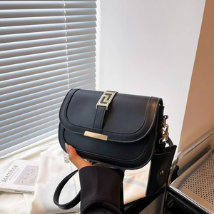 Black minimalist square crossbody bag with gold buckle and mini pouch accessory