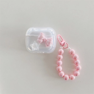 Detail of transparent AirPods case with pink bow, white star, and colorful bead lanyard
