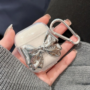Transparent AirPods case featuring a large silver liquid metal bow and silver carabiner
