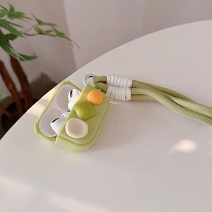 Detail of light green silicone AirPods case with 3D accents and woven wrist lanyard