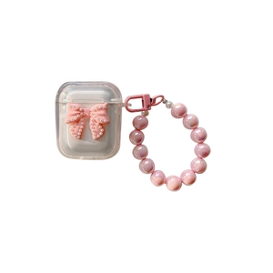 Pink bow AirPods case with pearl details and a colorful beaded wrist strap lanyard