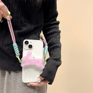Detail of pink bunny phone clip holder with a colorful braided neck strap on model