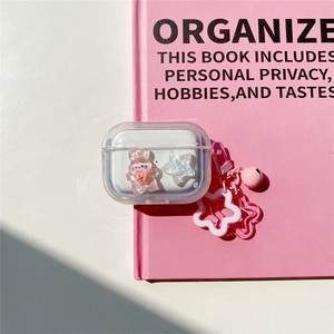 Detail of clear AirPods Pro case with 3D pink bunny, stars and matching metal keychain