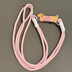 Pink braided crossbody phone strap featuring a cute cartoon dachshund acrylic charm