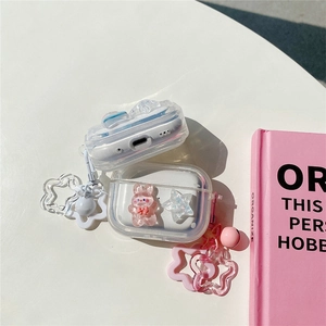 Detail of clear AirPods case featuring pink rabbit charm and star-shaped carabiner hook