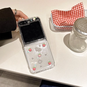Detailed shot of transparent Galaxy Z Flip case with strawberry and pearl decorations