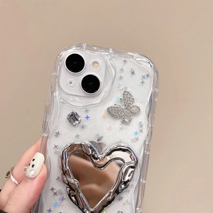 Close-up of glitter iPhone case with silver butterfly rhinestones and heart mirror