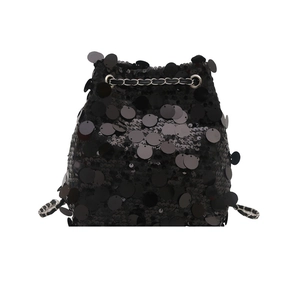 Fashionable black bucket bag with large glossy sequins and a silver chain strap for summer