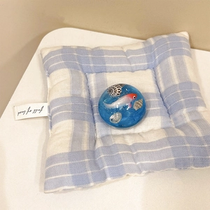 Detail of blue ocean resin phone grip with fish and shells on a checkered pad
