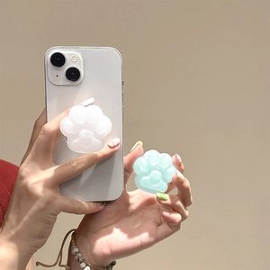 Close-up of cute cat paw phone grip tok in white and mint green on a smartphone