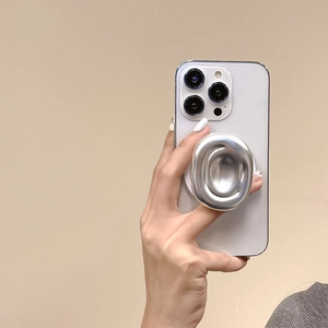 Close-up of a silver fluid geometric magnetic phone grip holder on a white smartphone