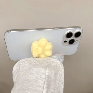 Close-up of a cute 3D cream cat paw pop socket stand on a smartphone back